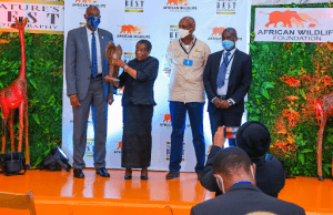 Mrs Anna Mkapa receives a token of appreciation from AWF CEO